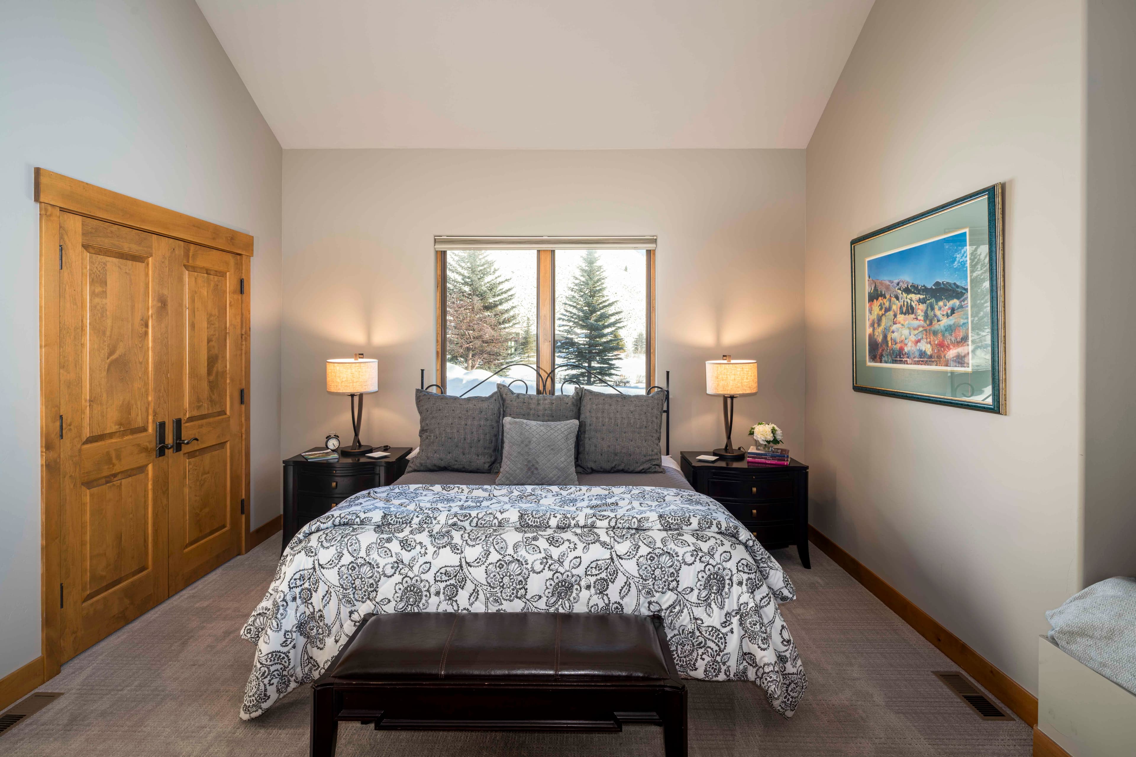 The largest non-primary bedroom in the house offers vaulted cathedral ceilings and space enough for anyone