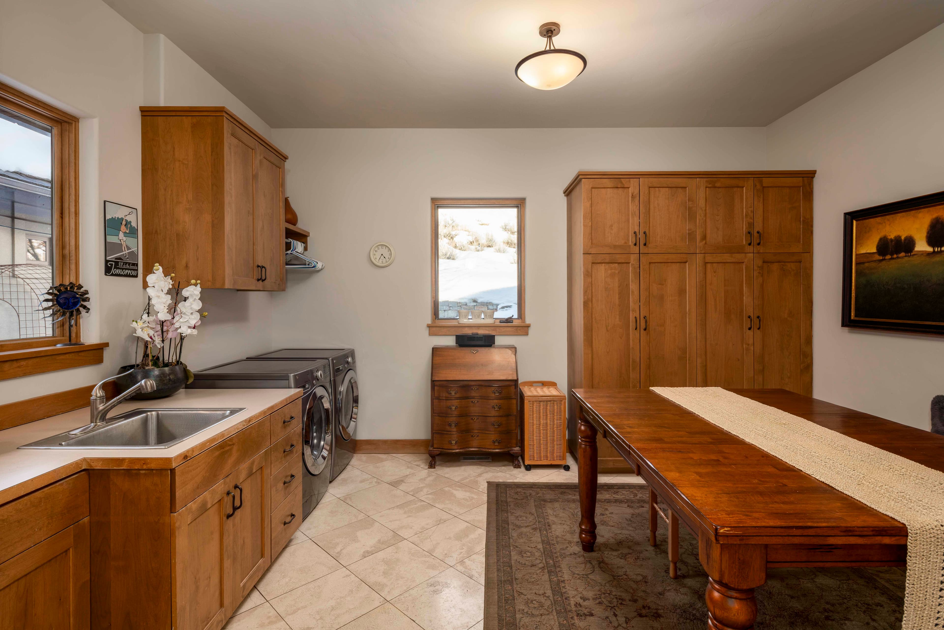 A spacious hobby/laundry room not only provides a large space for activity, but offers direct access to the three-car garage