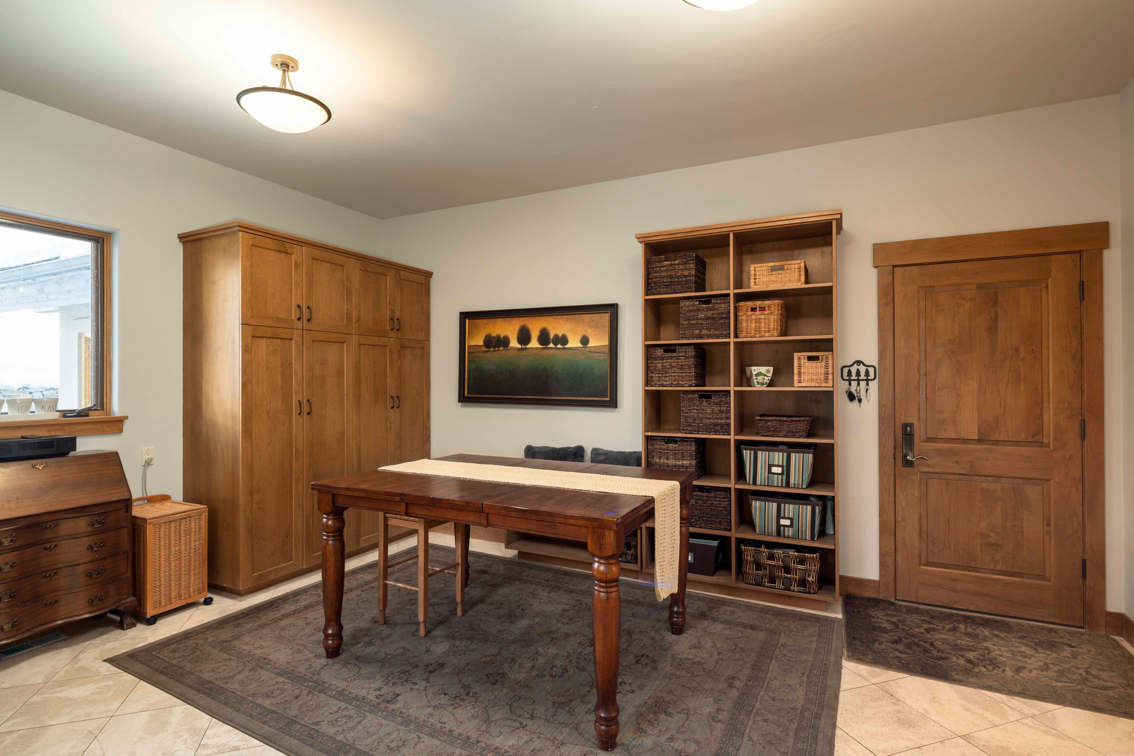 A spacious hobby/laundry room not only provides a large space for activity, but offers direct access to the three-car garage